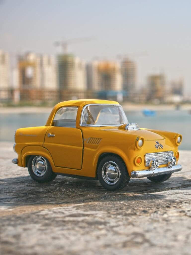 Selective Focus Photography of Yellow Car Toy