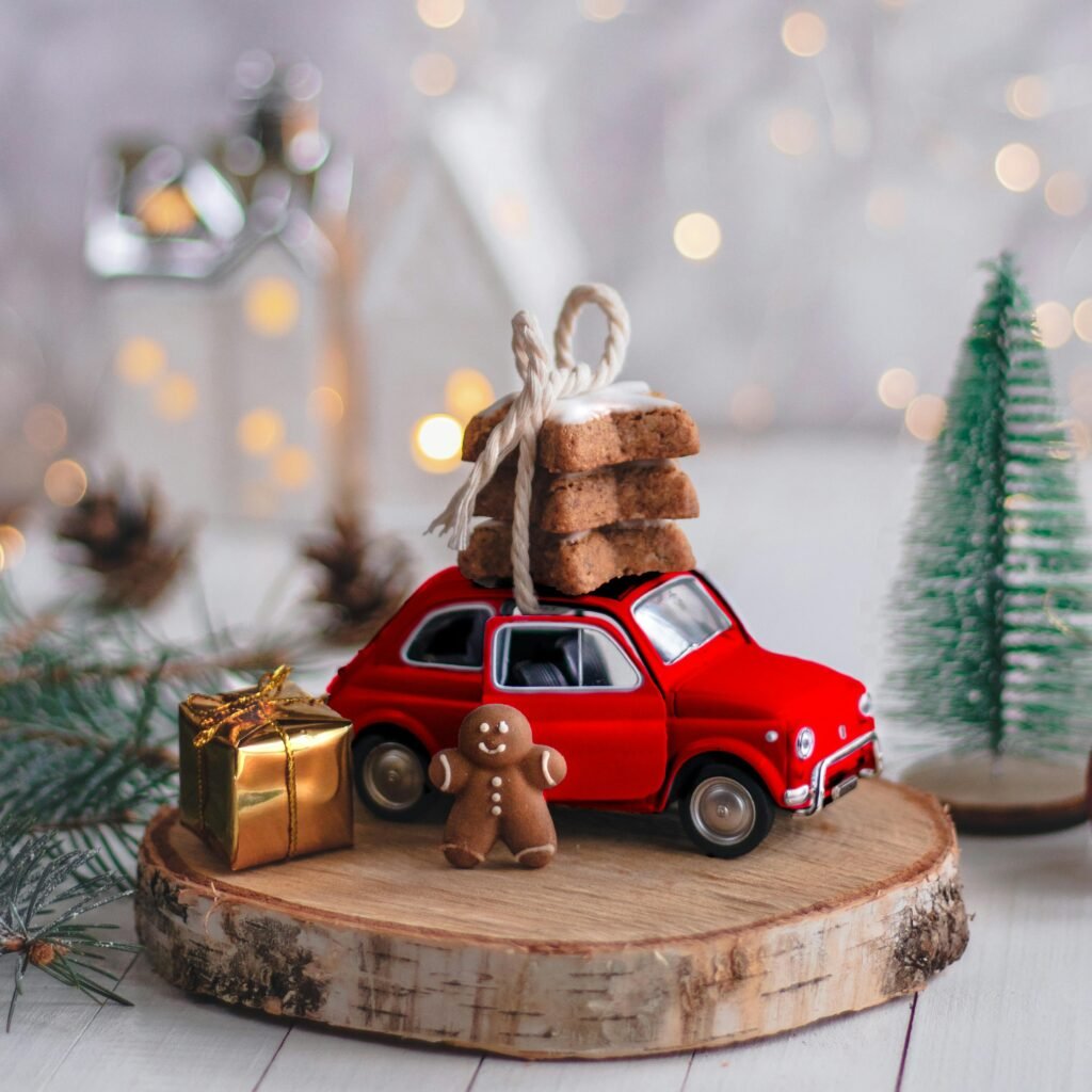 A whimsical Christmas scene with a toy car carrying cookies, a gingerbread man, and holiday decorations.